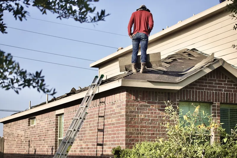 Professional roofer working on a residential roof in Liberty Hall